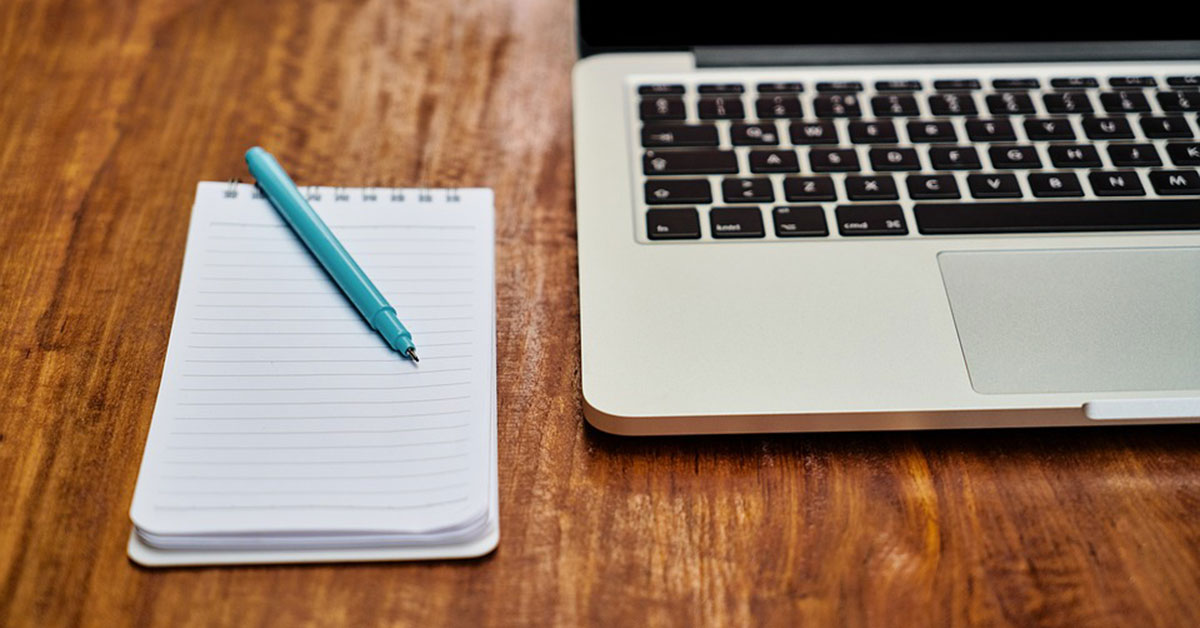 Laptop and reporter's notepad