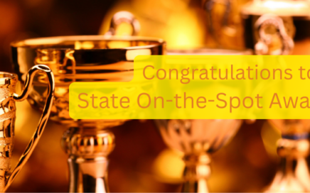 Several trophy cups lined up with the words, "congratulations to the state on the spot award winners"